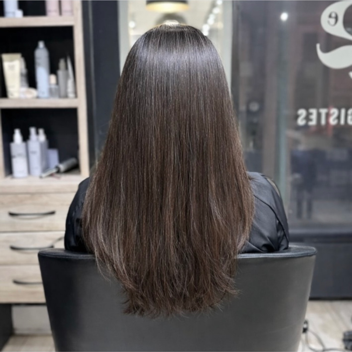 Long, straight brown hair after a smoothing treatment