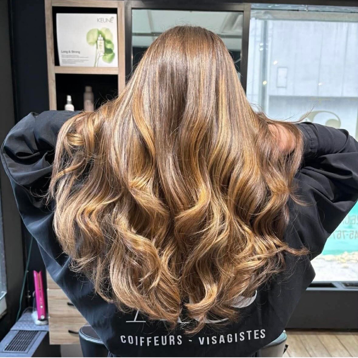 Balayage blond doré sur cheveux longs ondulés